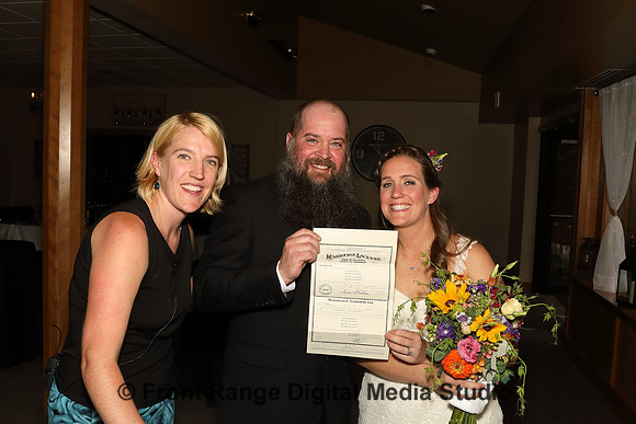 The officiant and the happy couple.