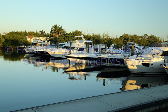 Boats at a marina with mirror smooth reflection