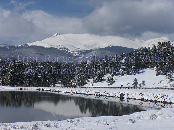 Lake reflecting snow scene